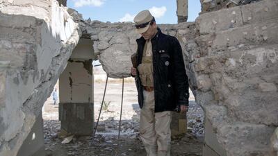 Soldiers keep watch in Afghanistan's Helmand. The building, formerly the office of the governmor of Nawa-i-Barakzay district, has been bombed and attacked by the Taliban, leaving ruins and bullet-riddled walls. Photo by Stefanie Glinski