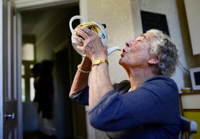 British children's writer and illustrator Judith Kerr drinks from a tea pot as she recreates a scene from her bestselling picture book 'The Tiger Who Came To Tea'. Reuters