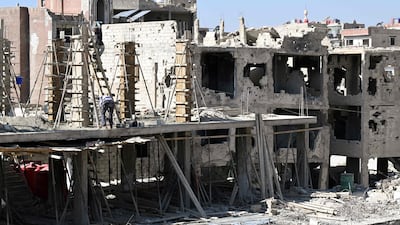Workers begin to reconstruct buildings destroyed during the civil war in the suburb of Darayya, Damascus, on October 30, 2025. AFP