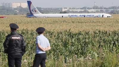 Russian police officers near the site of Ural Airlines A-321 passenger plane emergency landing outside Zhukovsky airport in Ramensky district of Moscow region, Russia. A-321 with 226 passengers and seven crew members on board en-route from Moscow to Simferopol made emergency landing after a right engine failure following the plane's colliding with seagulls shortly after take-off. Ten people were hospitalized following the accident. EPA
