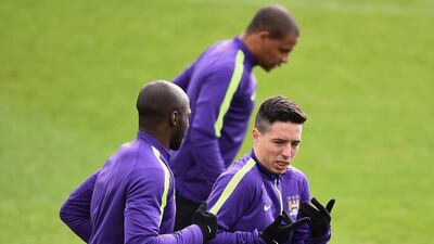 Eliaquim Mangala and Samir Nasri of Manchester City run during the team training session on Monday ahead of Tuesday night's Champions League match against Barcelona. Laurence Griffiths / Getty Images