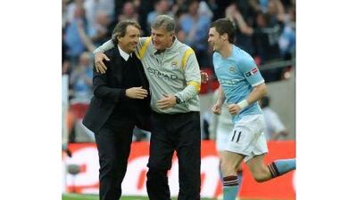 Roberto Mancini, left, the Manchester City manager, is congratulated by his assistant Brian Kidd after City's win on Saturday.