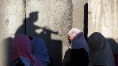 Palestinians wait to cross the Qalandia checkpoint between Ramallah and Jerusalem on their way to Al Aqsa Mosque. Abbas Momani / AFP