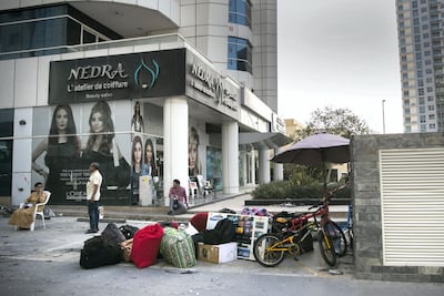 Residents' belongings are strewn outside the Zen Tower after a fire gutted the building in May. Reem Mohammed / The National