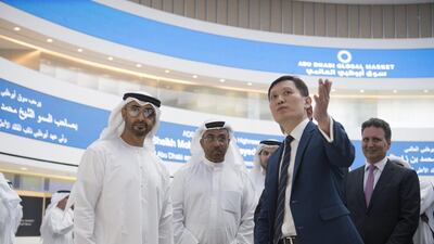 Sheikh Mohammed bin Zayed, Crown Prince of Abu Dhabi and Deputy Supreme Commander of the Armed Forces, speaks with Richard Teng, chief executive of the Financial Services Regulatory Authority at Abu Dhabi Global Market (3rd L), while visiting Abu Dhabi Global Market on Al Maryah Island with Ahmed Al Sayegh, Chairman of Abu Dhabi Global Market (back 2nd L). Hamad Al Kaabi / Crown Prince Court - Abu Dhabi