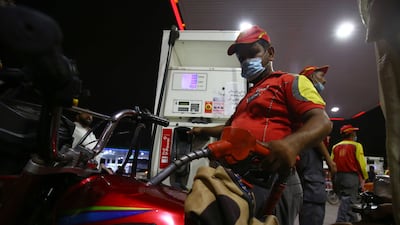 A gas station attendant fills a motorbike in Karachi. Fuel prices in Pakistan will rise from Friday. EPA