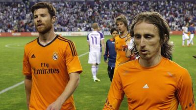 Real Madrid midfielders Xabi Alonso and Luka Modric leave the pitch at the end of their disappointing 1-1 draw with Real Valladolid on Wednesday. Cesar Manso / AFP / May 7, 2014