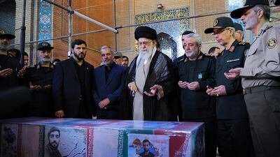Iranian supreme leader Ayatollah Ali Khamenei and military commanders pray over the coffin of Mohsen Hojaji, a young Revolutionary Guard soldier killed by ISIL in Syria, during his state funeral in Tehran on September 27, 2017. Office of the Iranian Supreme Leader via AP