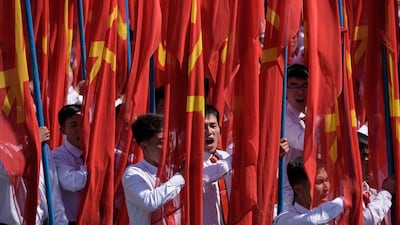 Students march past a balcony from where North Korea's leader Kim Jong Un was watching, during a mass rally on Kim Il Sung square in Pyongyang. AFP