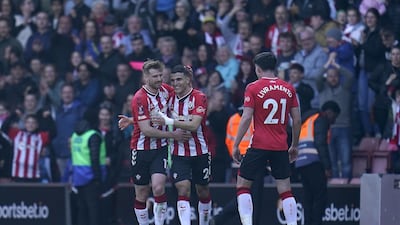 Southampton's Stuart Armstrong, left, and Mohamed Elyounoussi celebrate after Aymeric Laporte's own goal. PA