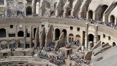 Tourists are seen visiting the ancient Colosseum as seen from the topmost floor. Andrew Medichini / AP Photo