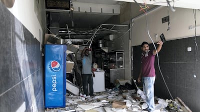 The clear-up gets underway after a gas explosion caused Dh200,000 of damage to an Ajman cafe. Reem Mohammed/The National