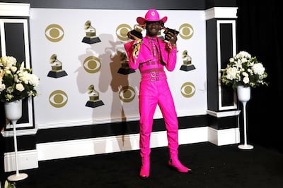 Lil Nas X poses in the press room with his Grammys. EPA