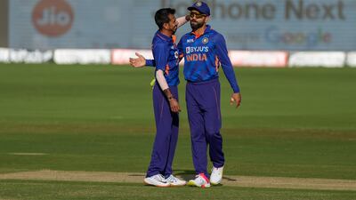 Yuzvendra Chahal is congratulated by Virat Kohli after taking a wicket against the West Indies on Sunday. AP