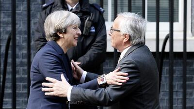 Britain's prime minister Theresa May greets European Commission president Jean-Claude Juncker outside 10 Downing Street in London on April 4, 2017. John Stillwell / PA via AP