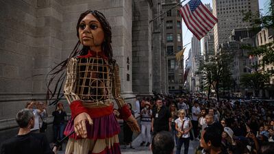 Little Amal, a giant puppet depicting a Syrian refugee girl, walks outside St Patrick's Cathedral in New York. AFP