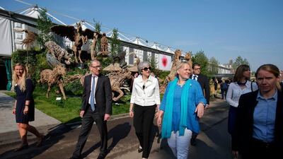 Mrs and Mr May are shown around the Chelsea Flower Show by RHS Director General Sue Biggs, second right.