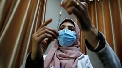 A health worker fills a syringe with the Covid-19 vaccine in Gaza city. Reuters
