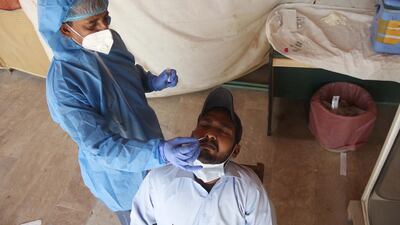 A health worker collects samples for Coronavirus testing at a Hospital after new cases of Covid-19 were reported in Hyderabad, Pakistan. EPA
