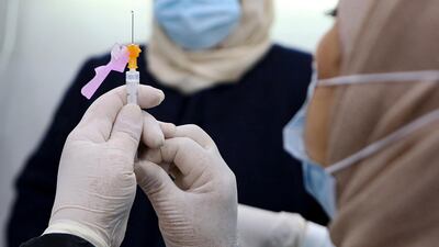 A medic prepares a Covid-19 vaccine injection. AFP