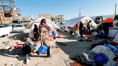 Iranians camp in tents and makeshift shelters outside damaged buildings in the town of Sarpol-e-Zahab in western Kermanshah province near the border with Iraq, following a 7.3-magnitude earthquake that left hundreds dead and thousands homeless / AFP