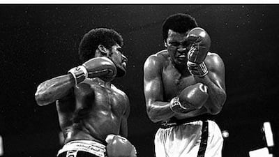Muhammad Ali grimaces as Leon Spinks lands a hard left and gets ready to unload with his right fist.