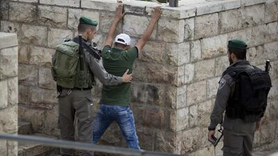 An Israeli border police officer searching a Palestinian man at the Damascus Gate of Jerusalem's Old City ahead of Friday prayers on October 23, 2015. Israel’s parliament has passed a law expanding police powers to stop and frisk suspected criminals as the country faces over four months of near-daily Palestinian attacks on Israelis. Ariel Schalit/AP Photo