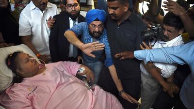 Egyptian Eman Ahmed Abd El Aty is taken on a stretcher towards an ambulance at a hospital in Mumbai on May 4, 2017 ahead of her trip to the UAE. Punit Paranjpe / AFP