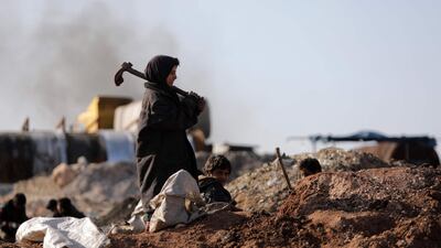 A young child working at a makeshift oil refinery near Tarhin, in Aleppo, Syria. AFP