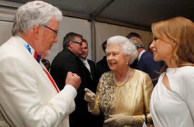 Queen Elizabeth II meets Australian entertainers Rolf Harris, left, and Kylie Minogue at the Diamond Jubilee Concert outside Buckingham Palace in June 2012. Reuters