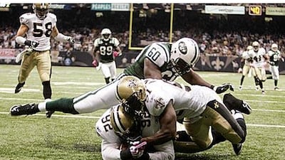 The New Orleans Saints defensive tackle Remi Ayodele (92) recovers a New York Jets fumble in the end zone for a touchdown.