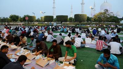 People breaking their fast on the first day of Ramadan at the Sheikh Zayed Grand Mosque in Abu Dhabi. Pawan Singh / The National