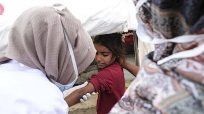 A child who fled the Turkish incursion in Northern Syria receives medicine for polio and measles in Dohuk, Iraq. Getty Images