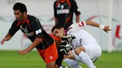 Al Ain's Mohannad Salem trips up the Ajman player Ali Abbas Samerrah during a 1-0 victory for Ain, who are managed by the German Winfried Schaefer at the Khalifa Bin Zayed Stadium.