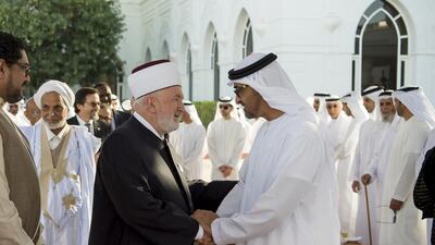 Sheikh Mohammed bin Zayed, Crown Prince of Abu Dhabi and Deputy Supreme Commander of the Armed Forces, greets to a participant of the Forum for Promoting Peace in Muslim Societies, during a reception at a Sea Palace barza. Rashed Al Mansoori / Crown Prince Court — Abu Dhabi
