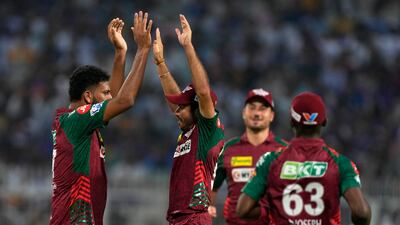 Lucknow Super Giants' Mohsin Khan, left, celebrates the wicket of Kolkata Knight Riders' Angkrish Raghuvanshi. AP