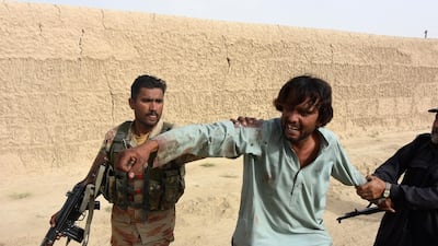 A man reacts after a suicide bomb attack that targeted an election campaign rally in Mastung, Pakistan, 13 July 2018. EPA