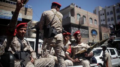 Military police ride on the back of a patrol truck as they secure a road where people held a ceremony commemorating the anniversary of the 2011 uprising that toppled Yemen's former president Ali Abdullah Saleh in Taiz, Yemen on February 11, 2018. Anees Mahyoub / Reuters