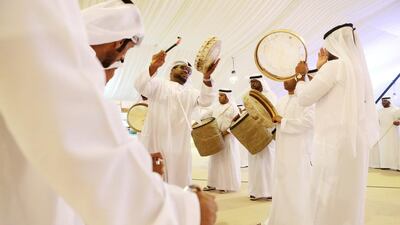 Emirati men perform a traditional dance during the first day of the Liwa Date Festival in the Western Region of Abu Dhabi.