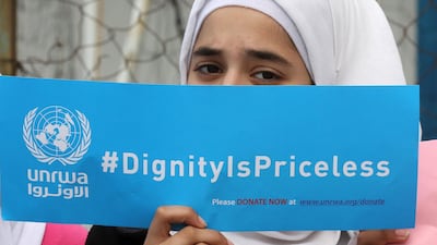A Palestinian refugee holds a placard at a school belonging to UNRWA in the town of Sebline, east of the southern Lebanese port of Sidon, on March 12, 2018, during a protest against US aid cuts to the organisation. Mahmoud Zayyat / AFP