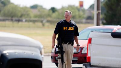 A law enforcement officer stands in the middle of the 5100 block of E. 42nd Street in Odessa, Texas following a shooting at random in the area of Odessa and Midland. Several people were dead after a gunman who hijacked a postal service vehicle in West Texas shot more than 20 people, authorities said Saturday. The gunman was killed and a few law enforcement officers were among the injured. AP