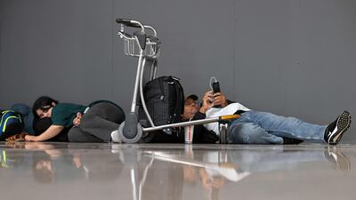 Passengers affected by the strike, involving Ryanair employees, wait to change their ticket at El Prat airport in Barcelona, Spain. AFP