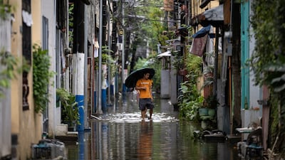 A man wades through floodwater following heavy monsoon rain in Pasig City, Metro Manila, the Philippines. Reuters