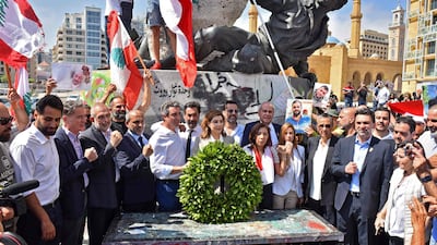 Thirteen independent candidates who previously took part in Lebanon's 2019 protest movement pose in front of the Martyrs' Statue in Beirut last month. AFP