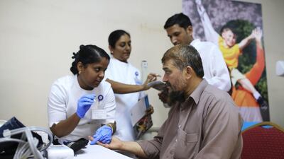 A healthcare company provides free medical assistance to workers unable to afford specialist care. Sarah Dea / The National