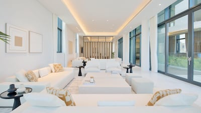 A sleek, bright-white and generously sized formal living room. Courtesy Luxhabitat Sotheby's International Realty