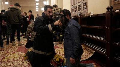 An anti-government protester receives treatment after confrontation with Lebanese riot police inside the Mohammad al-Amin Mosque in Beirut. AP Photo