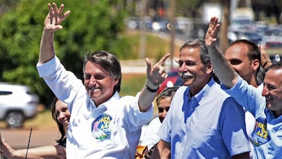 Brazilian right-wing presidential candidate Jair Bolsonaro greets supporers at a campaign rally in the district of Ceilandia in Brasilia. Evarusto Sa / AFP