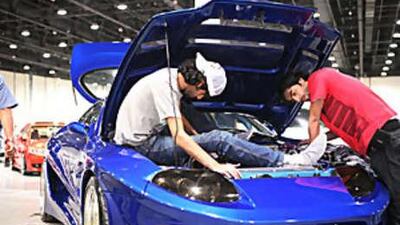 Jassim Khaled and Ammar Darood polish their cousin's car before judging took place.