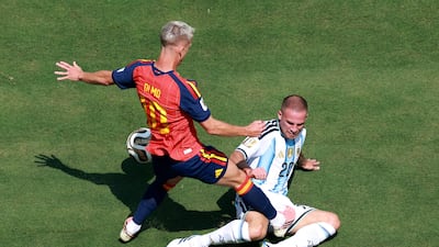 Argentina's Alexis Mac Allister was lucky not to be booked for this challenge on Dani Olmo of Spain. AFP